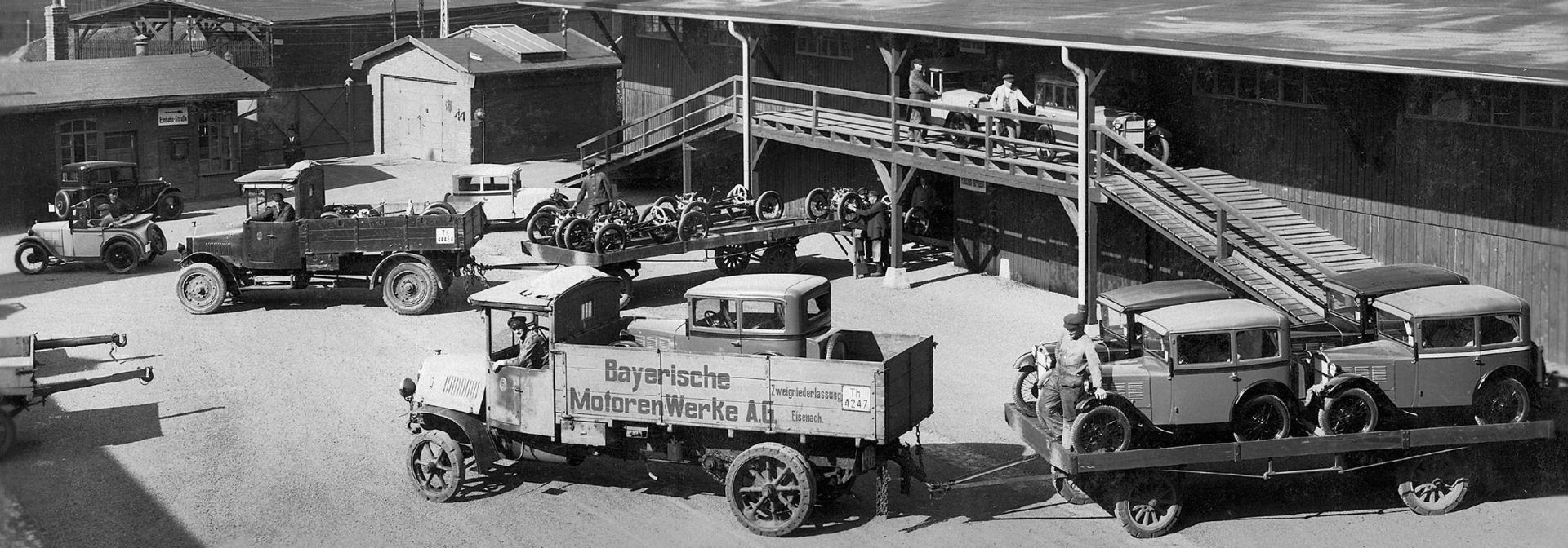 Historic BMW vehicles are being transported on trucks