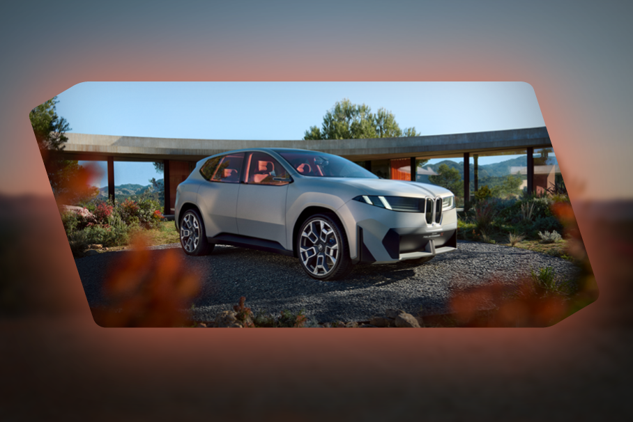 Silver BMW concept SUV parked in front of circular architecture in daylight, with the slogan “More Than Ever” below.