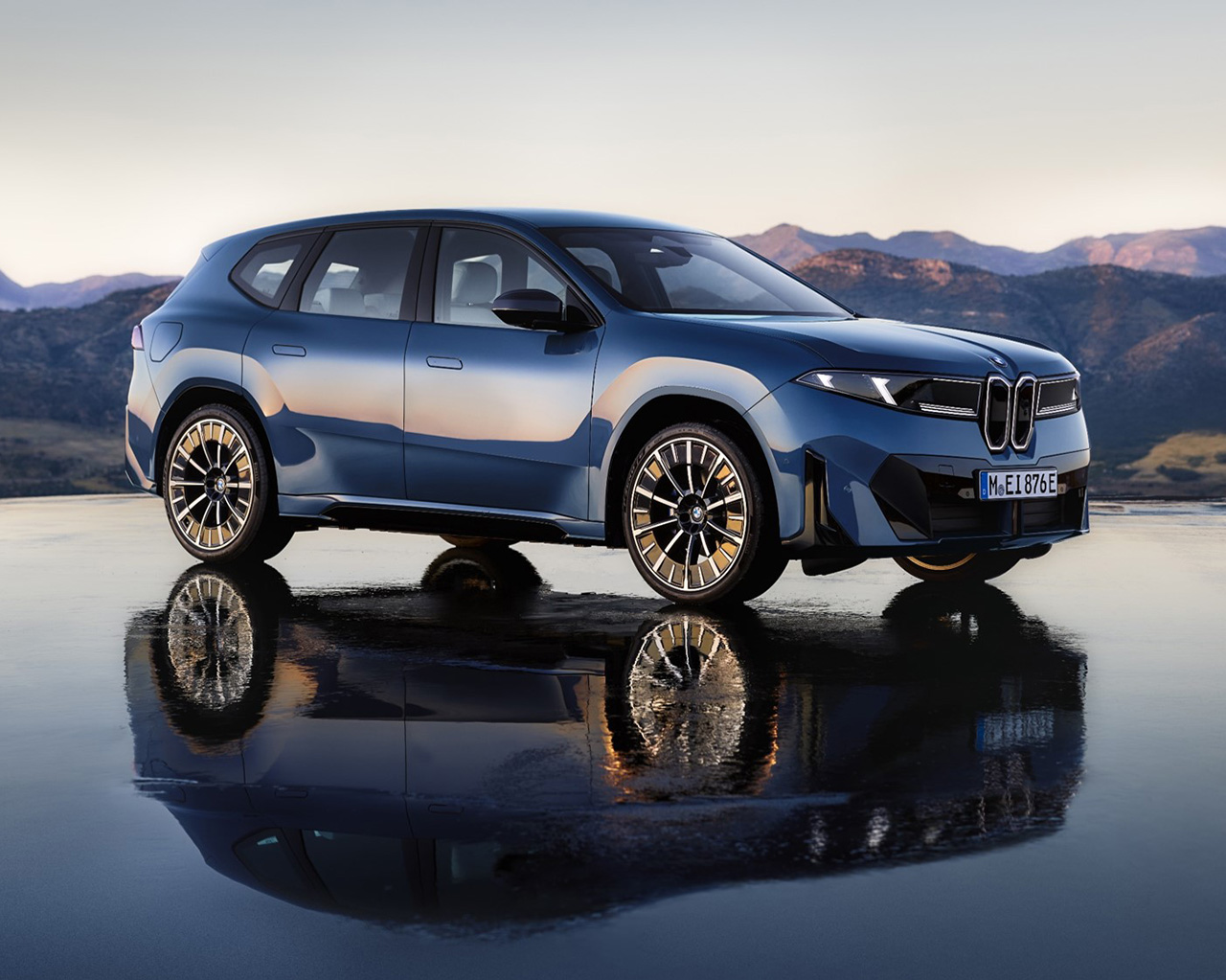 Side view of the new BMW iX3 with impressive natural backdrop.