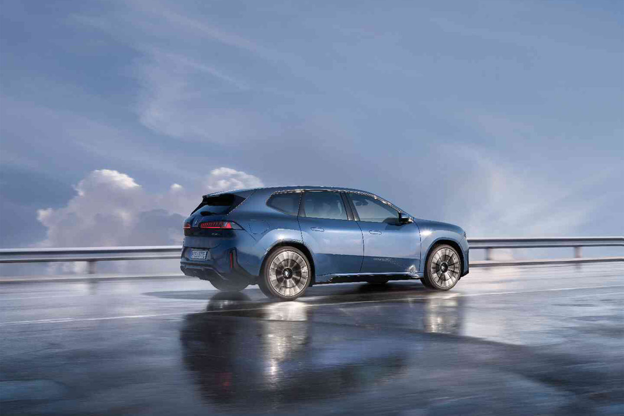 BMW Neue Klasse electric concept car with modern design driving on a road.