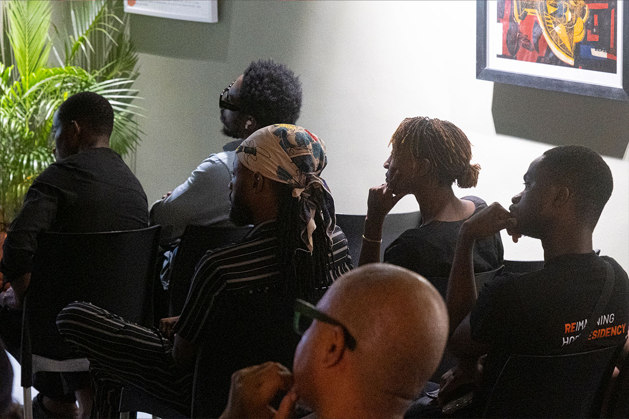 A group of african people sitting together listening to a presentation