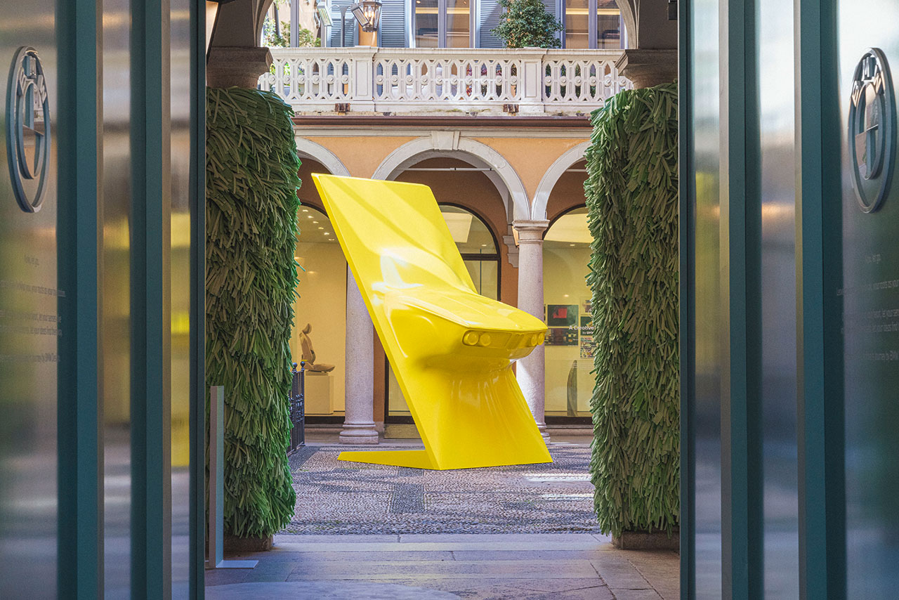 A sculpture of the front of a historic BMW standing in a beautiful courtyard