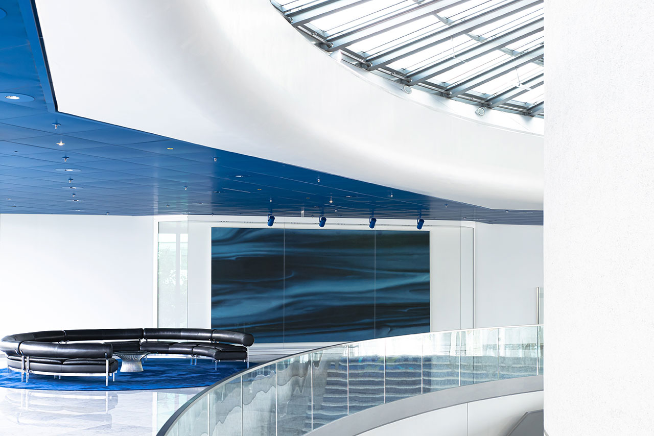 A modern room with a blue painting hanging on the wall