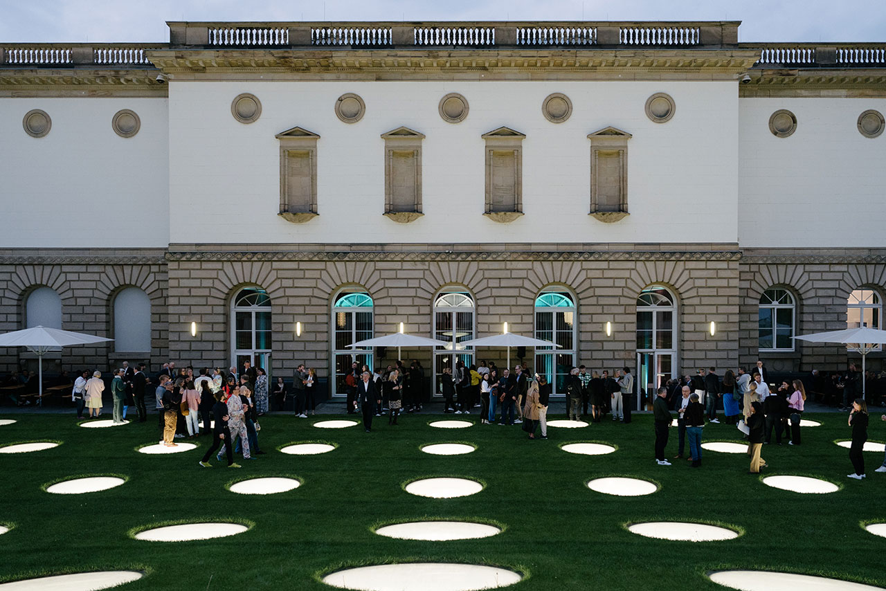 get together on a beautiful meadow in front of a historic building