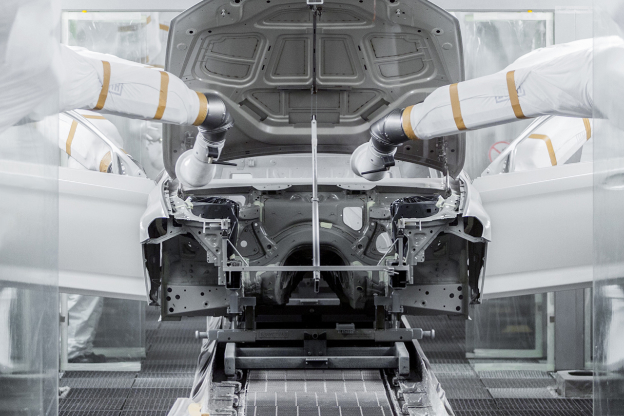 Robotic arms working on a car body inside the BMW Group iFactory-Industrie 4.0.