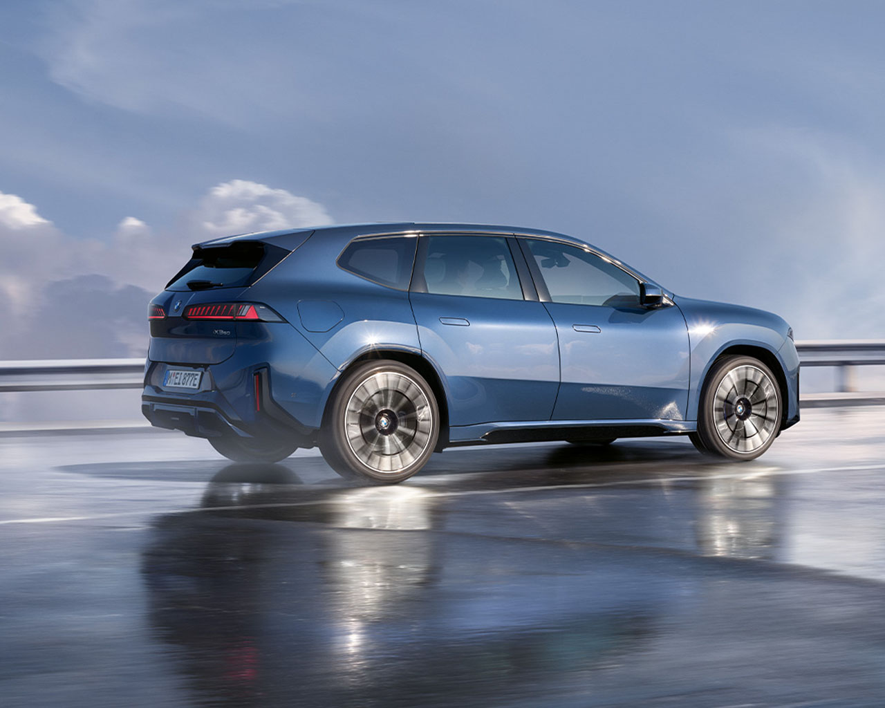 BMW iX3 Neue Klasse electric car with modern design driving on a wet road.