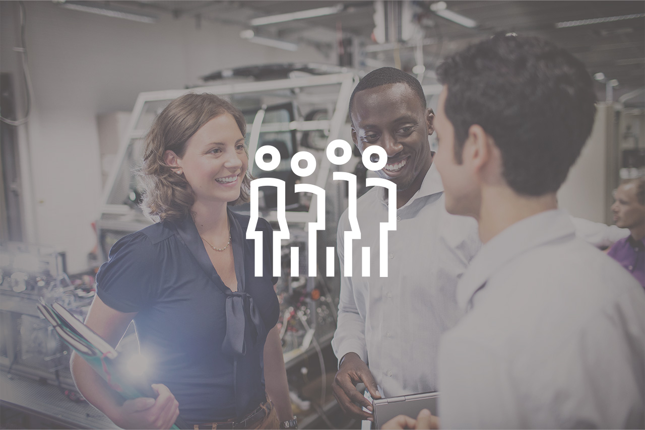 A group of professionals discussing ideas in a modern workspace with a Group-Icon.