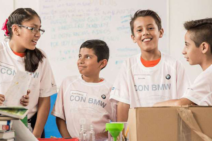 Four happy children with BMW t-shirts