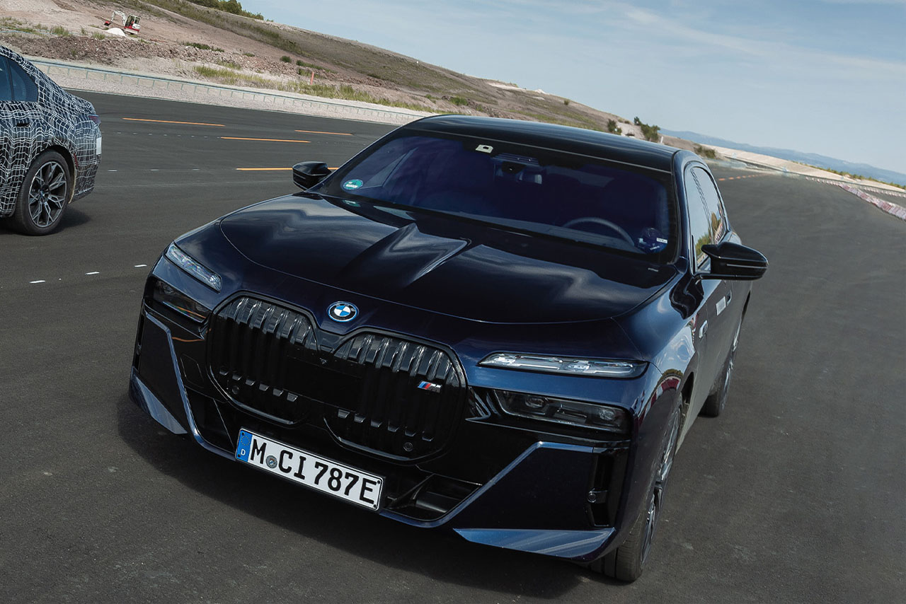 BMW vehicle on a road through the desert.