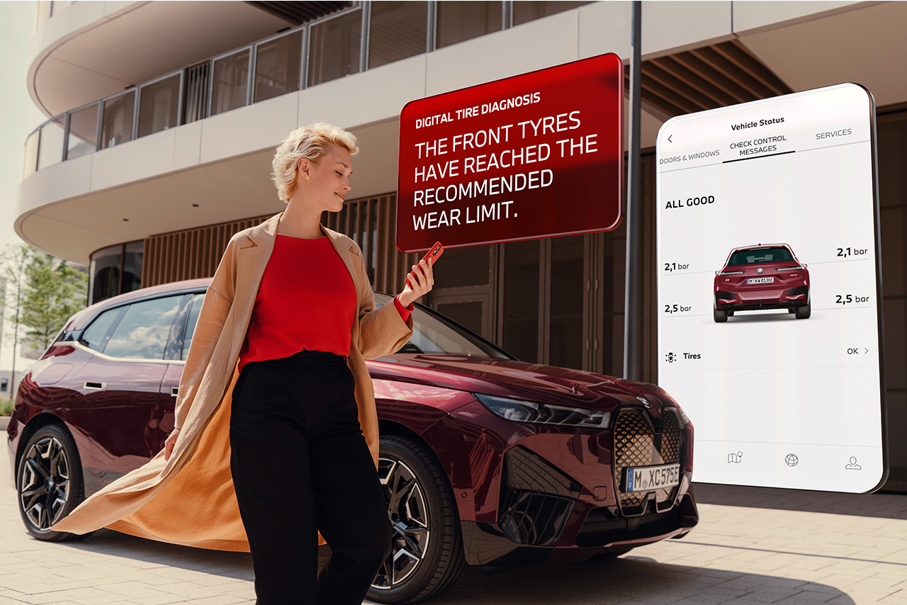A young woman is checking her car on the smartphone