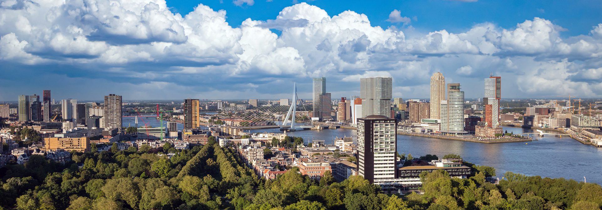 Rotterdam Netherlands cityscape and Erasmus bridge. Panoramic view from Euromast tower, sunny day	
