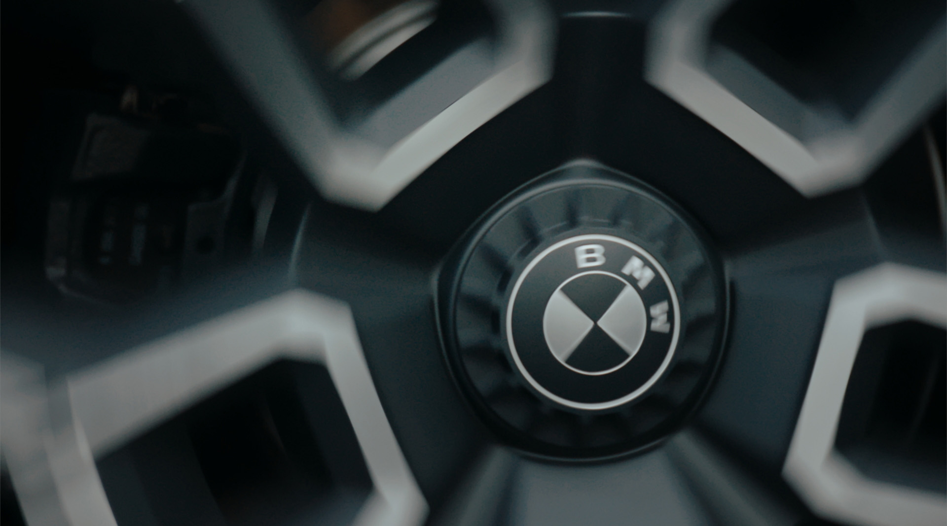 A BMW wheel rim in motion, recognisable by the blur.